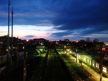 High angle view of railroad tracks against sky at night