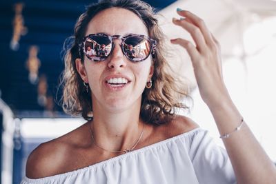 Portrait of smiling young woman wearing sunglasses