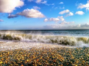 Scenic view of sea against cloudy sky