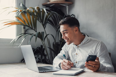 Male friends using laptop at home