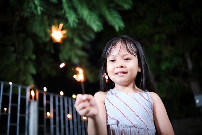 Child playing fireworks in new year celebration at night
