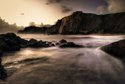 Scenic view of sea against rocky coastline