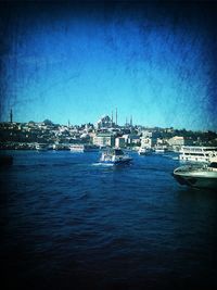 Boats in harbor with buildings in background