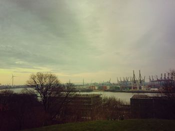 View of field against cloudy sky