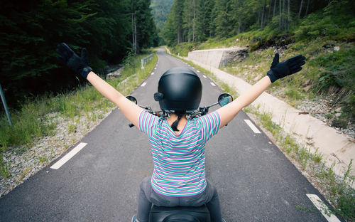 Rear view of man standing on road