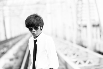 Man standing at railway bridge