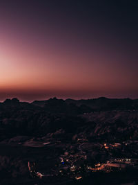 High angle view of illuminated mountain against sky at sunset