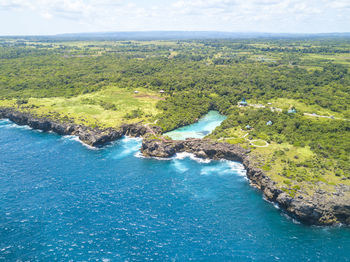 Aerial view of island against sky during sunny day