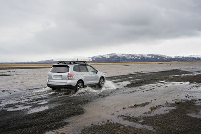 Car crossing stream in iceland