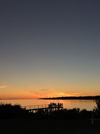 Scenic view of lake against orange sky