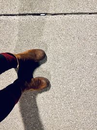 Low section of man standing on footpath