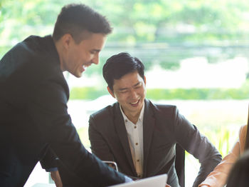 People working by table in office