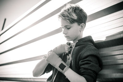 Boy wearing boxing glove while standing outdoors