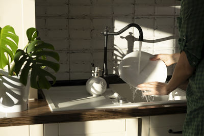 Midsection of woman preparing food in kitchen