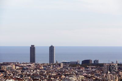 High angle view of buildings by sea against sky