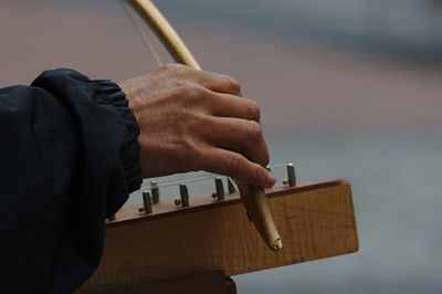 Man playing guitar on wood