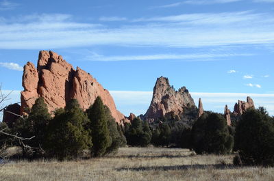 Rock formations on landscape against sky