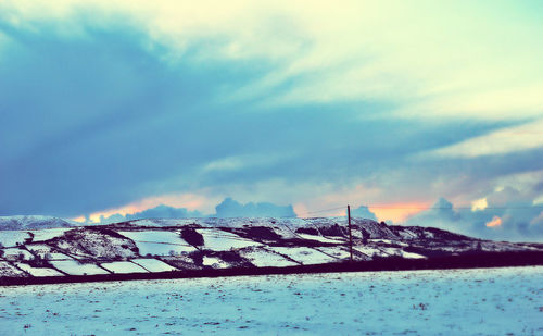 Scenic view of mountains against sky during winter