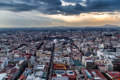 Cityscape against cloudy sky