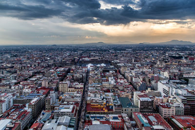 High angle view of residential district against sky during sunset