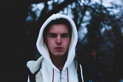 Close-up portrait of young man against tree