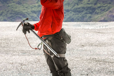 Midsection of hiker standing on mountain