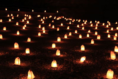 Close-up of illuminated candles in temple