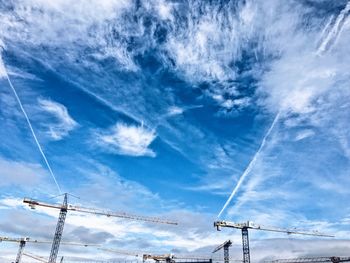 Low angle view of power lines against blue sky