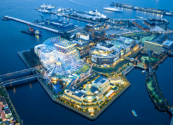 High angle view of illuminated ferris wheel in city