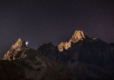 Low angle view of mountain range at night