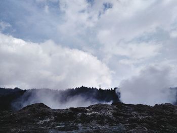 Scenic view of waterfall against sky at dieng