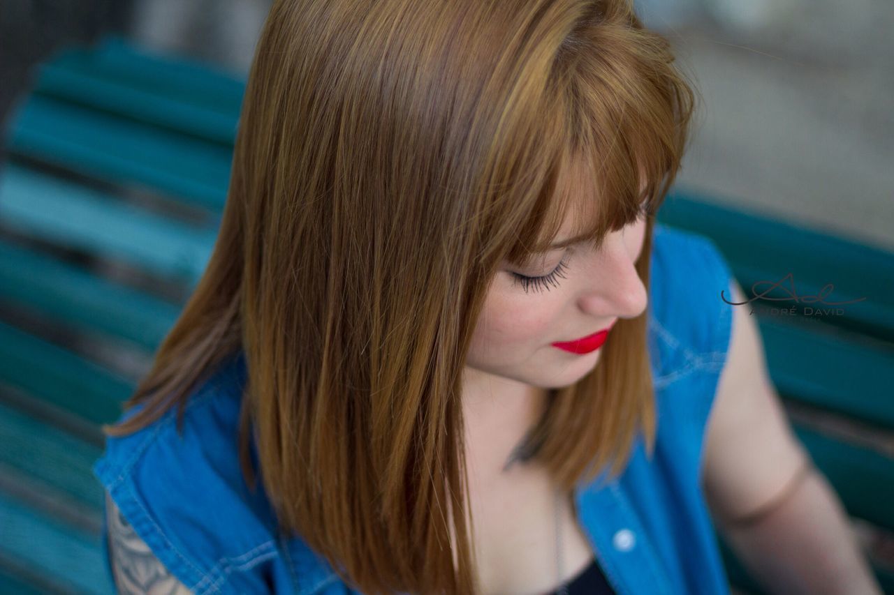 long hair, headshot, young adult, brown hair, close-up, looking down, blond hair, young women, selective focus, person, casual clothing, focus on foreground, day, beauty, human face, straight hair, beautiful people