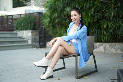 Portrait of smiling woman sitting on seat