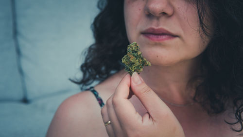 Close-up portrait of a beautiful woman holding flower