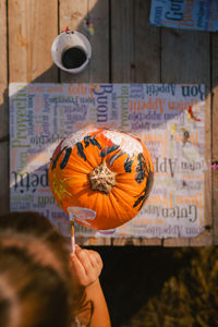 Cropped hand holding pumpkin