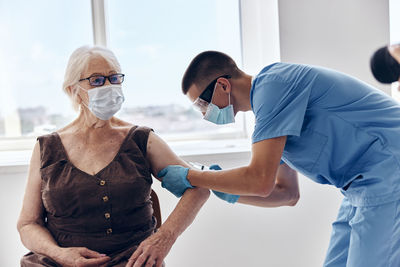 Rear view of people standing at home