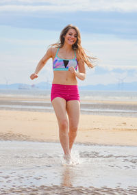 Full length of a beautiful young woman on beach