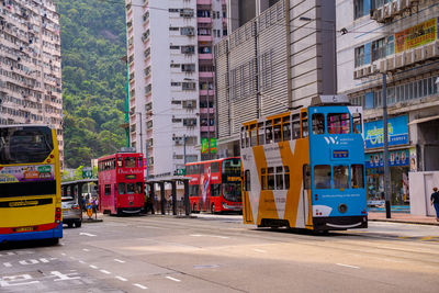 Cars on street amidst buildings in city