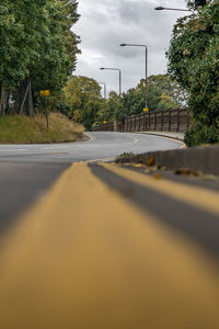 Surface level of road against sky in city