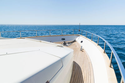 Boat sailing in sea against clear sky