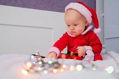 Cute kid playing with lighting equipment at home