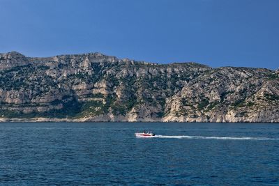 Scenic view of sea against clear blue sky