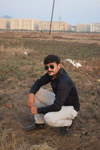 Young man sitting on field