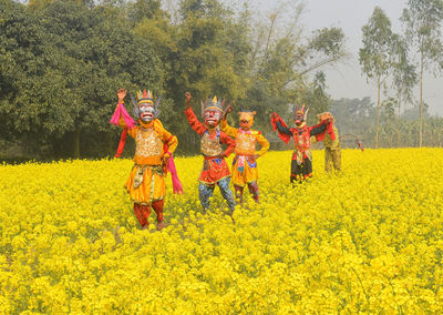 Woman with yellow flowers in field