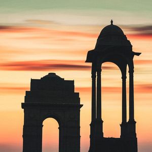 Silhouette of statue against sky during sunset