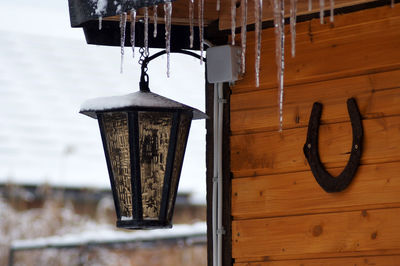 Close-up of light bulb hanging on wood