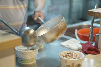 Midsection of man preparing food