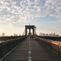 Brooklyn bridge against cloudy sky