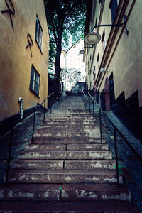 Low angle view of steps amidst buildings