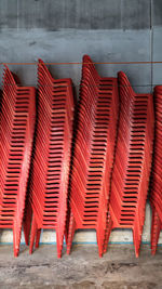 Close-up of red chairs against wall